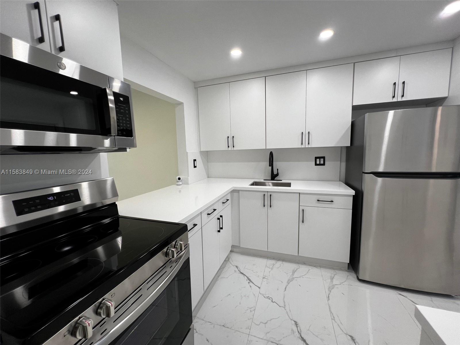 a kitchen with a sink stove and refrigerator