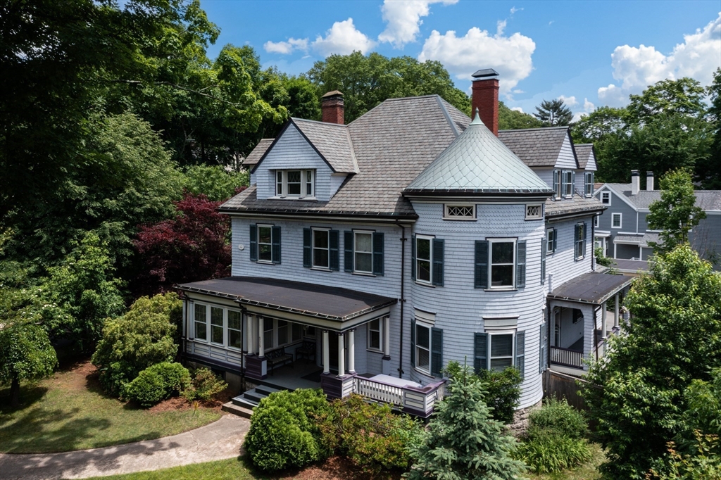 a aerial view of a house next to a yard