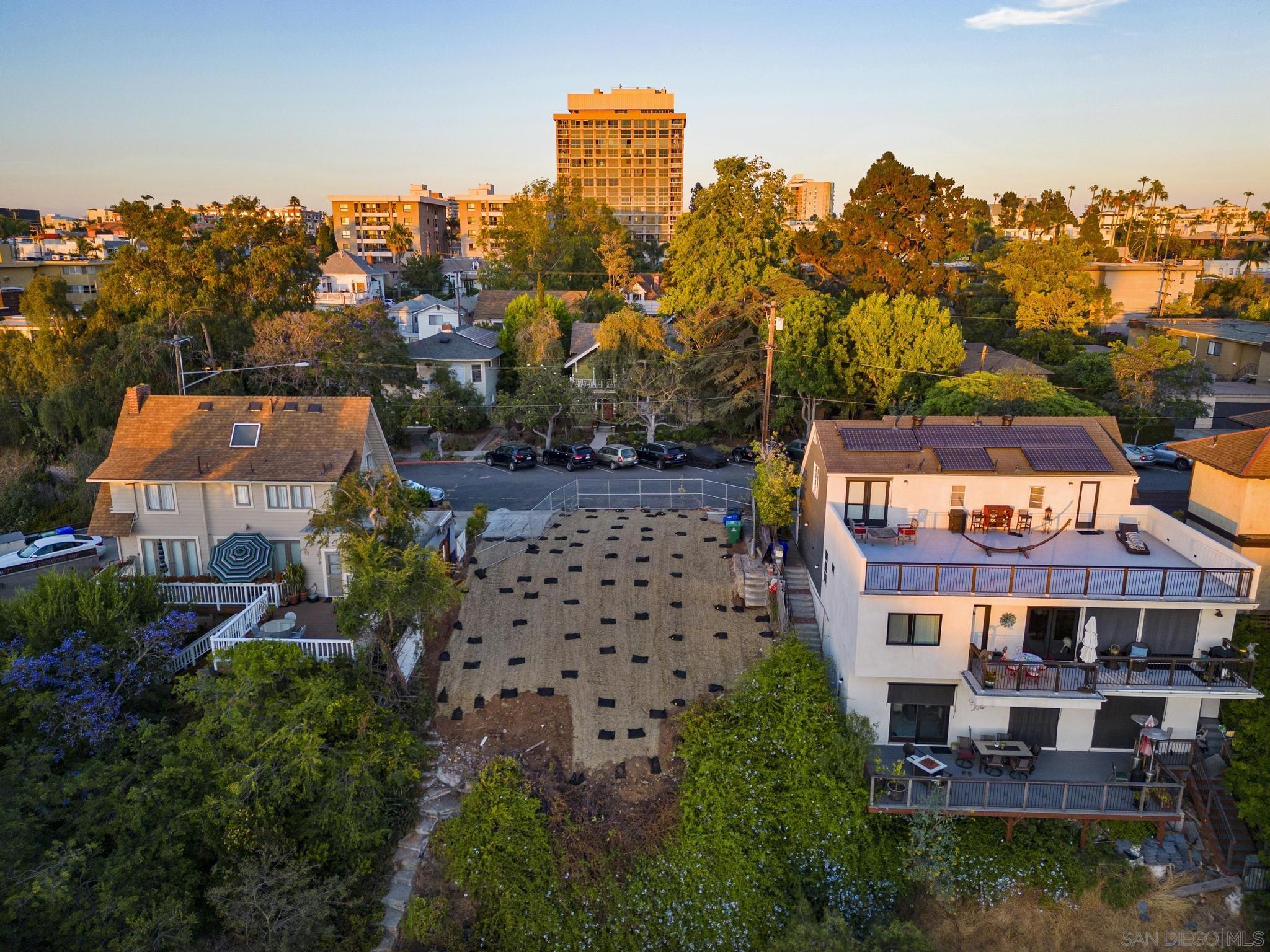 an aerial view of multiple houses with a yard