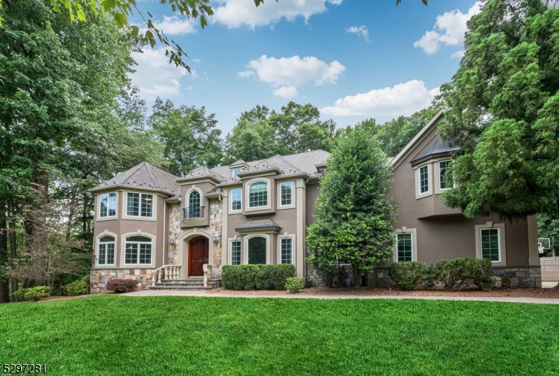 a front view of a house with a yard and trees