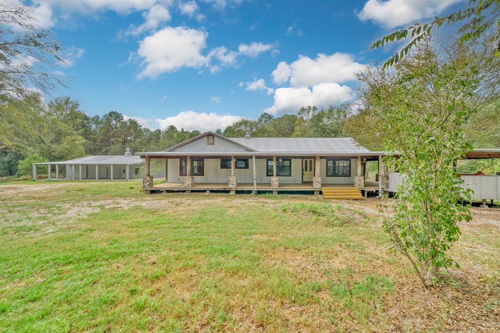 a front view of a house with a big yard