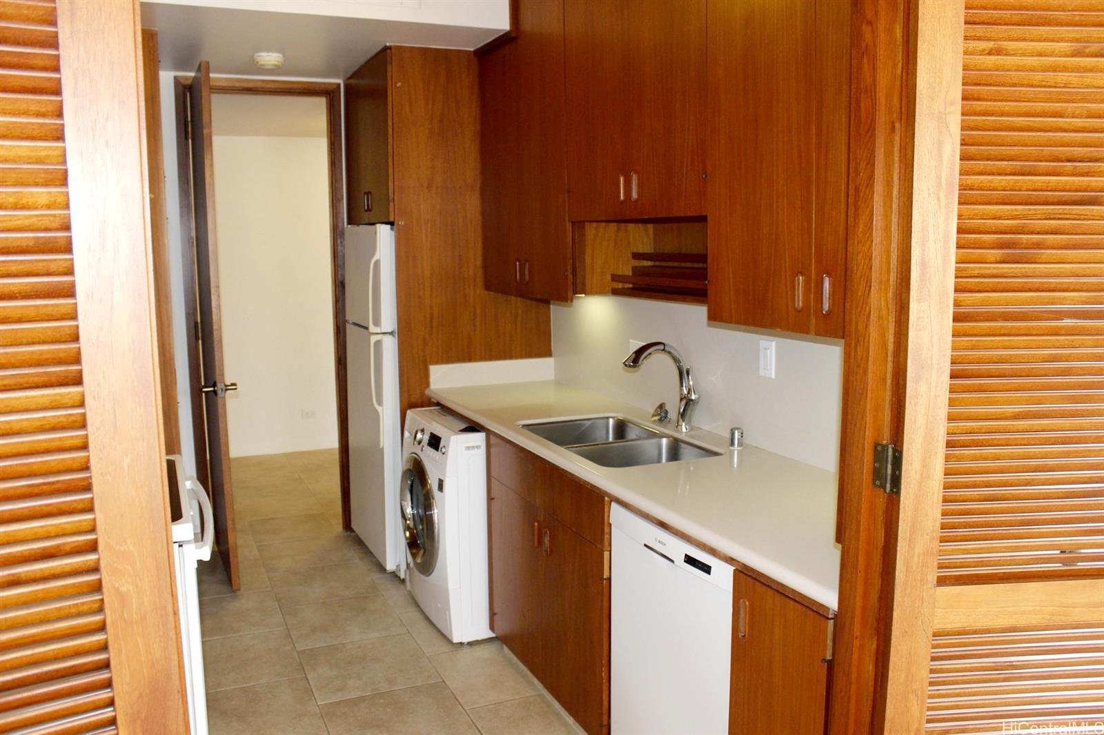 a kitchen with a sink and a refrigerator