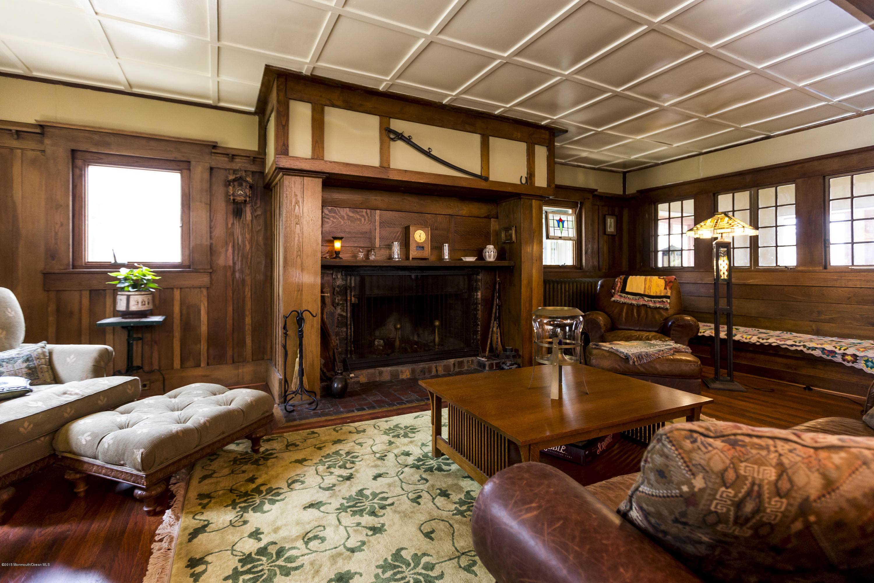 a living room with furniture a fireplace and a table