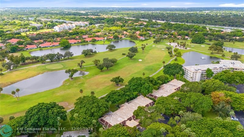 an aerial view of residential houses with outdoor space and river