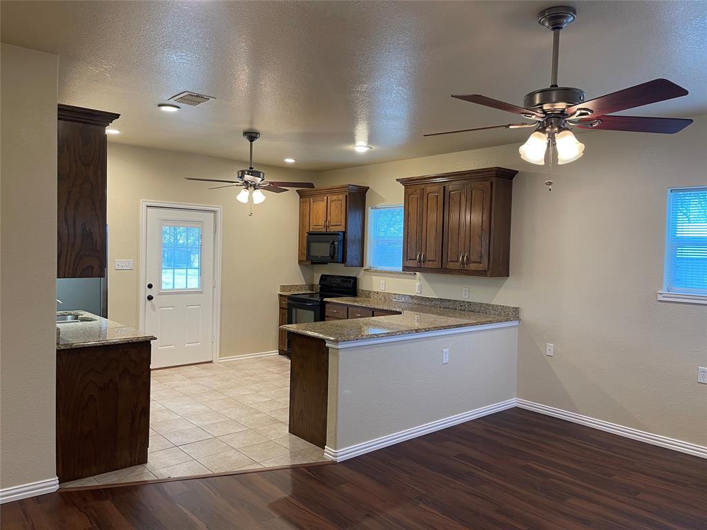 a view of a kitchen counter top space and wooden floor