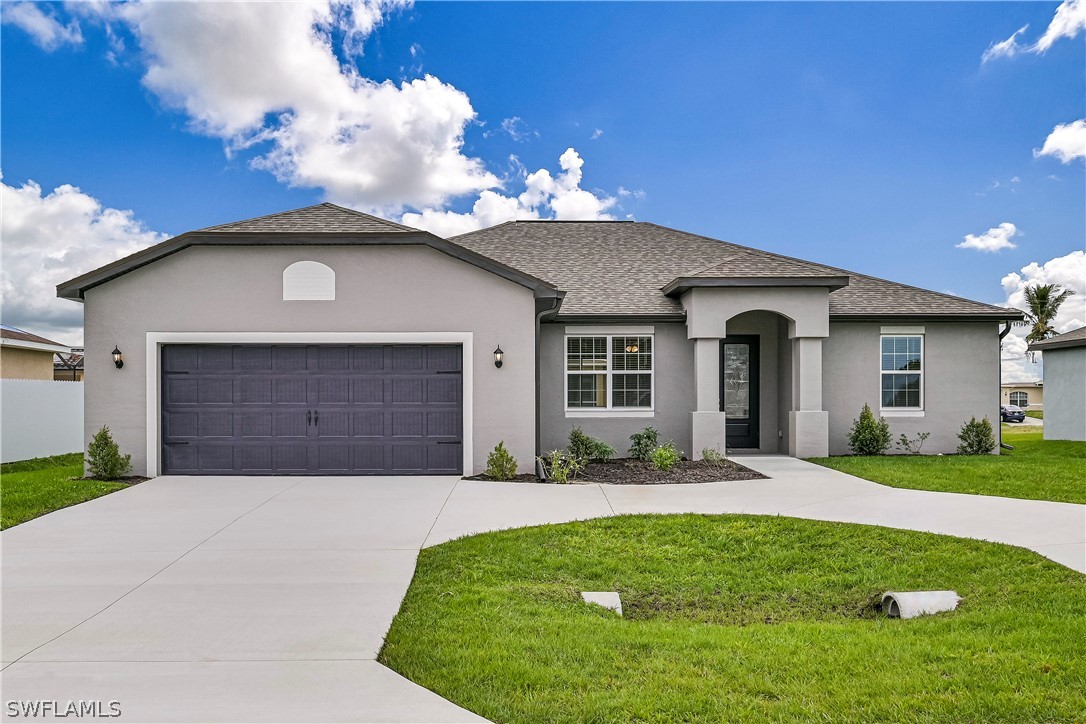 a front view of a house with a yard and garage