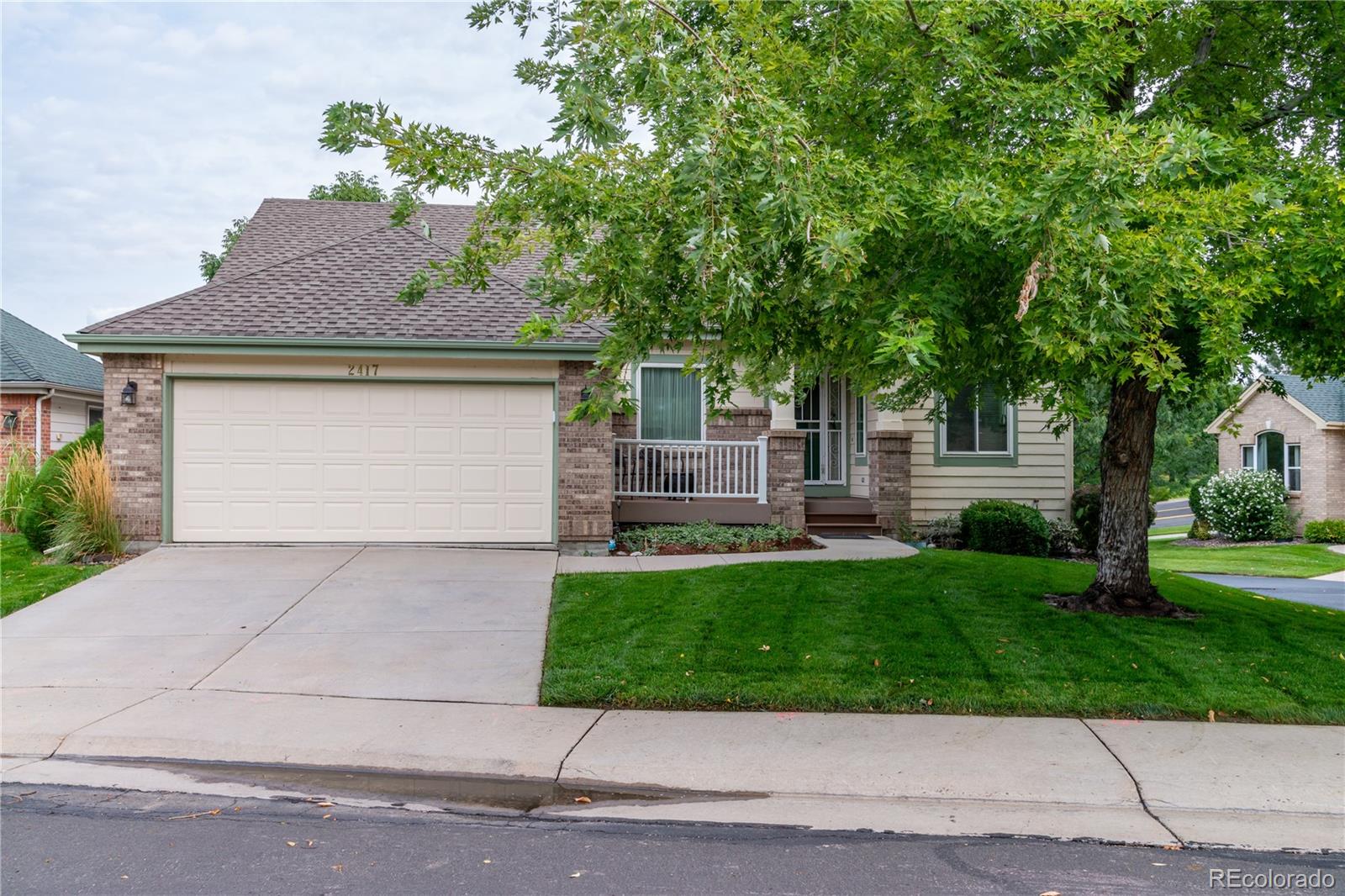 a front view of a house with a yard garage and outdoor seating