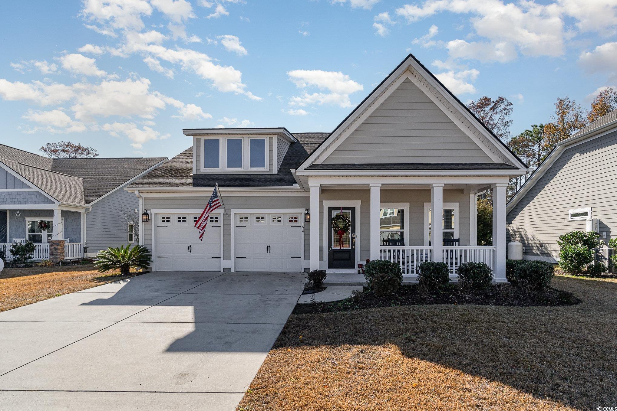 View of front of house featuring covered porch and