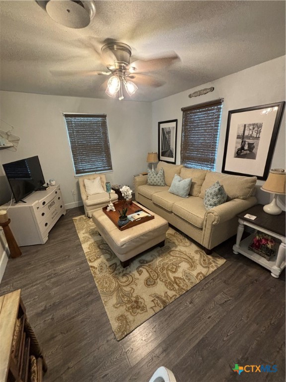 a living room with couches and a dining table with wooden floor