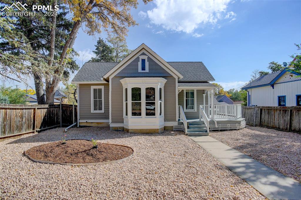 a front view of a house with a yard and outdoor seating