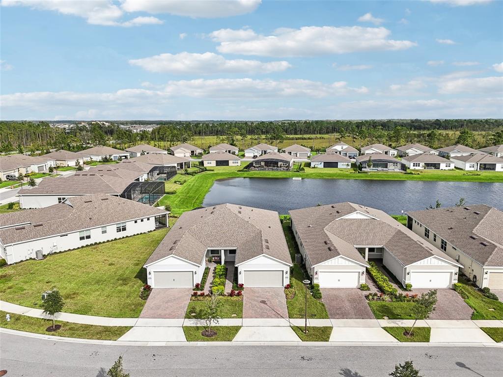 an aerial view of a house with garden space and ocean view