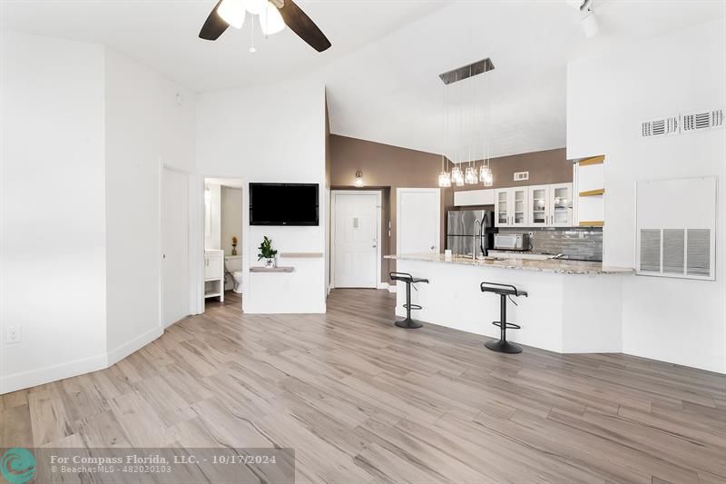 a view of kitchen with furniture and refrigerator