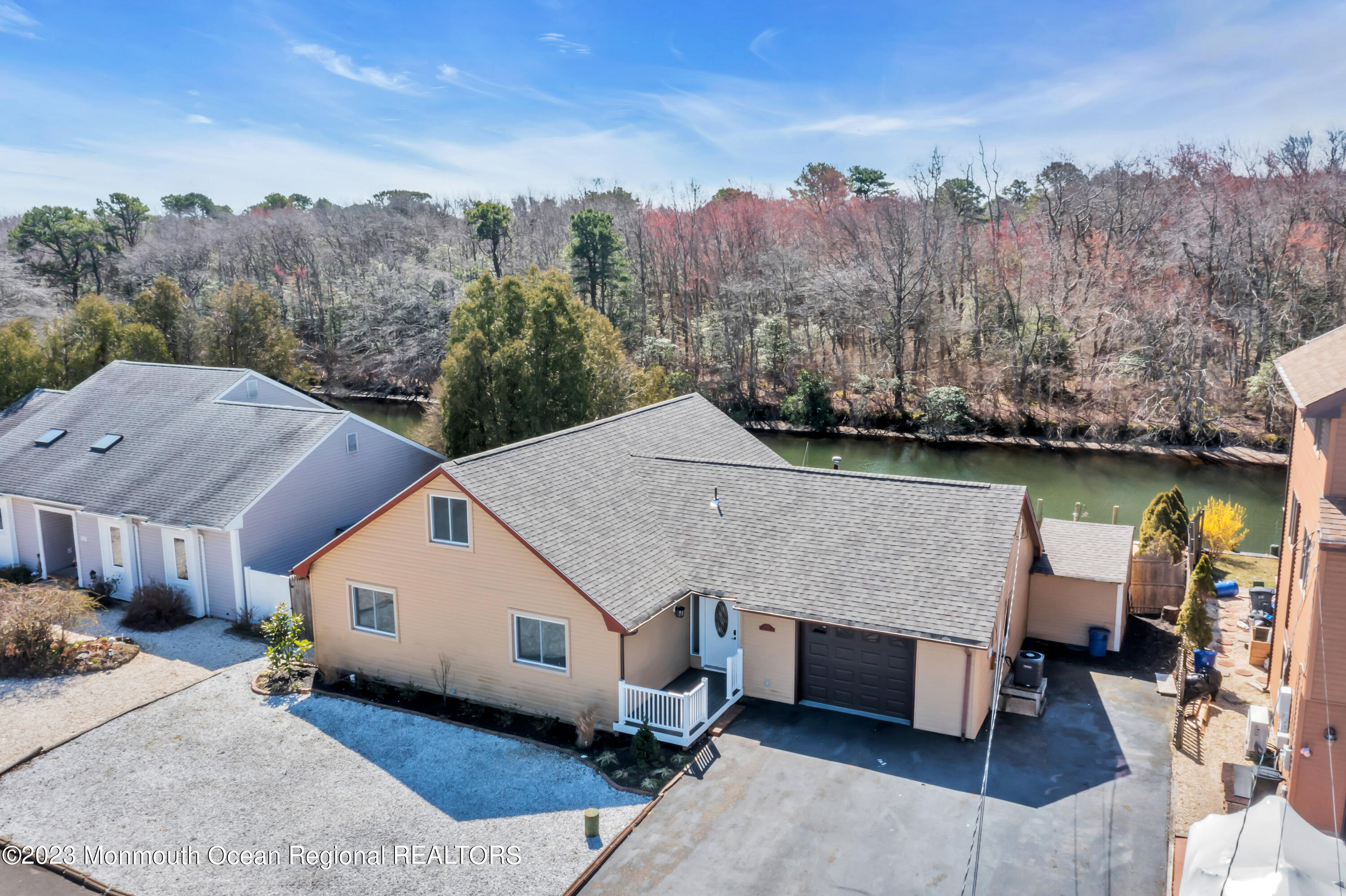 a aerial view of a house next to a yard