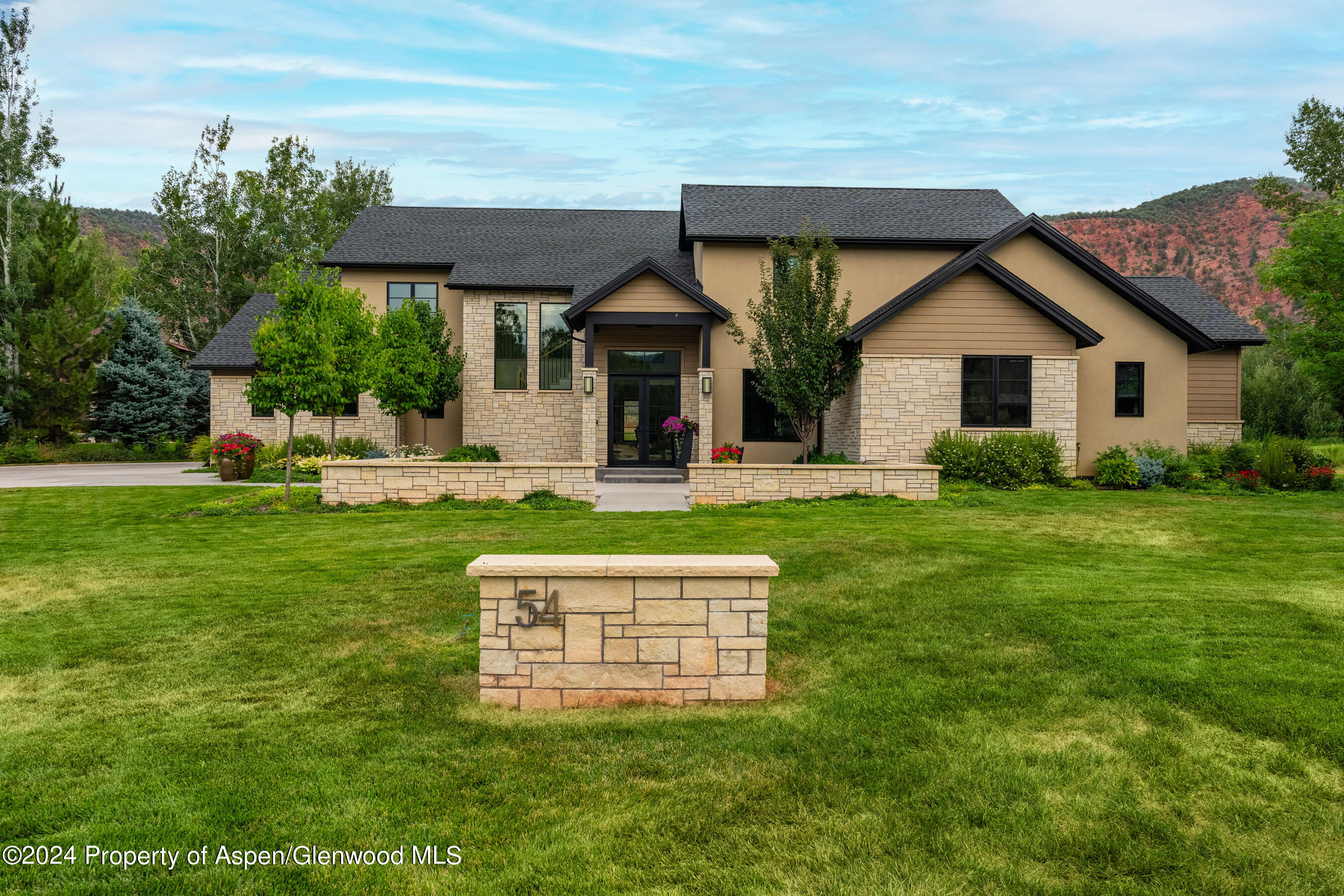 a front view of house with yard and green space