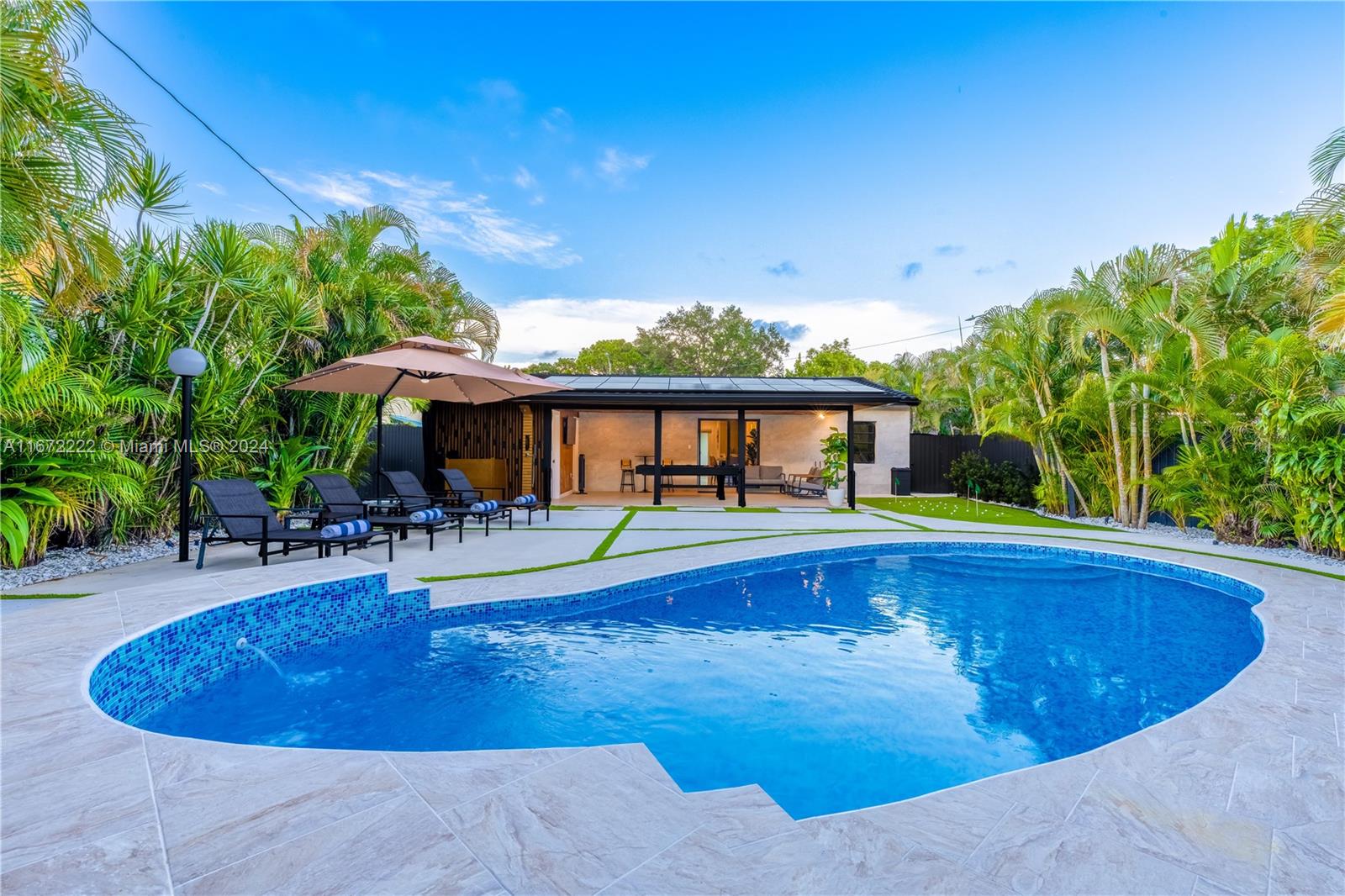 a view of swimming pool with outdoor seating