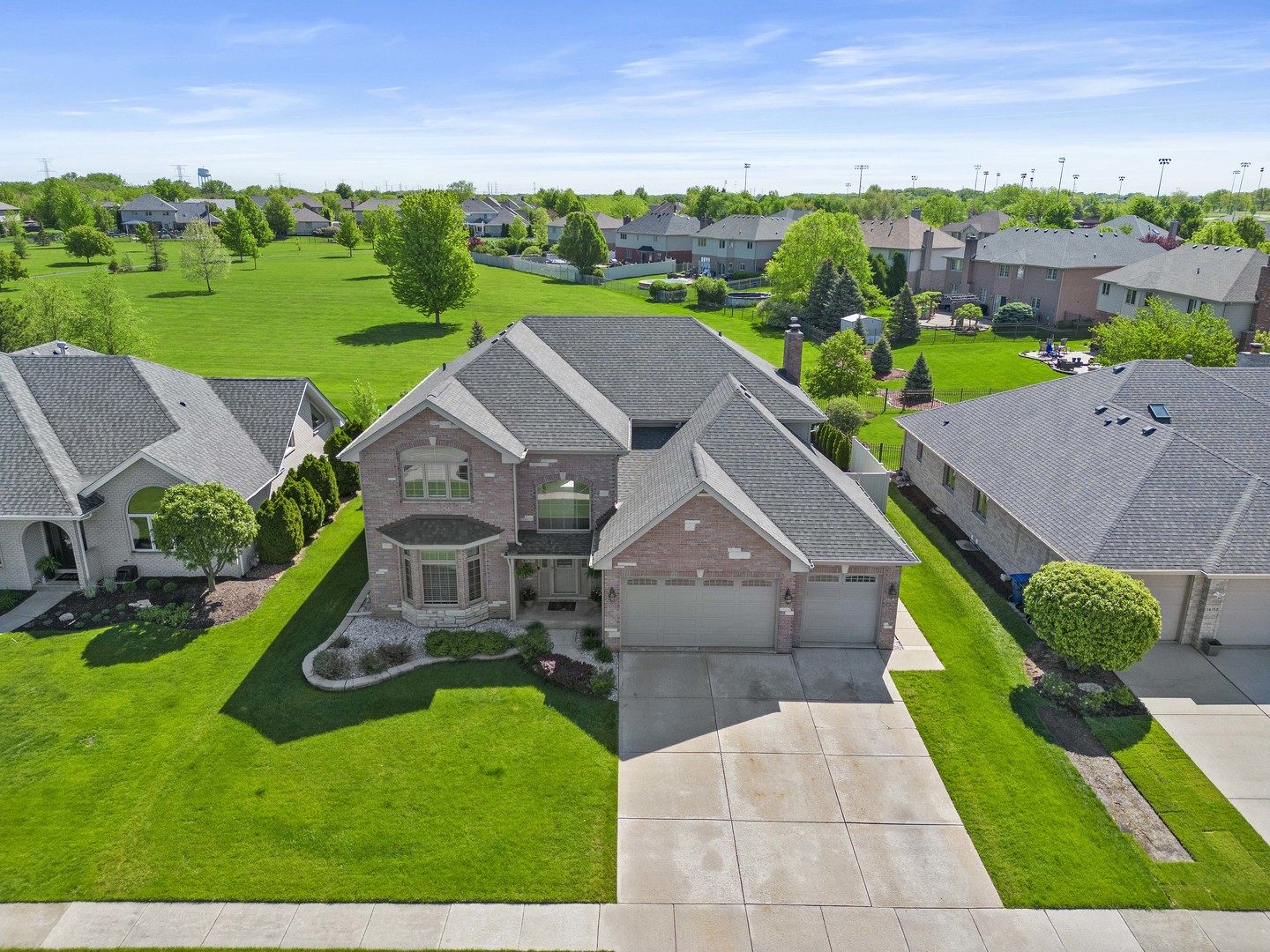 an aerial view of a house with garden space and street view