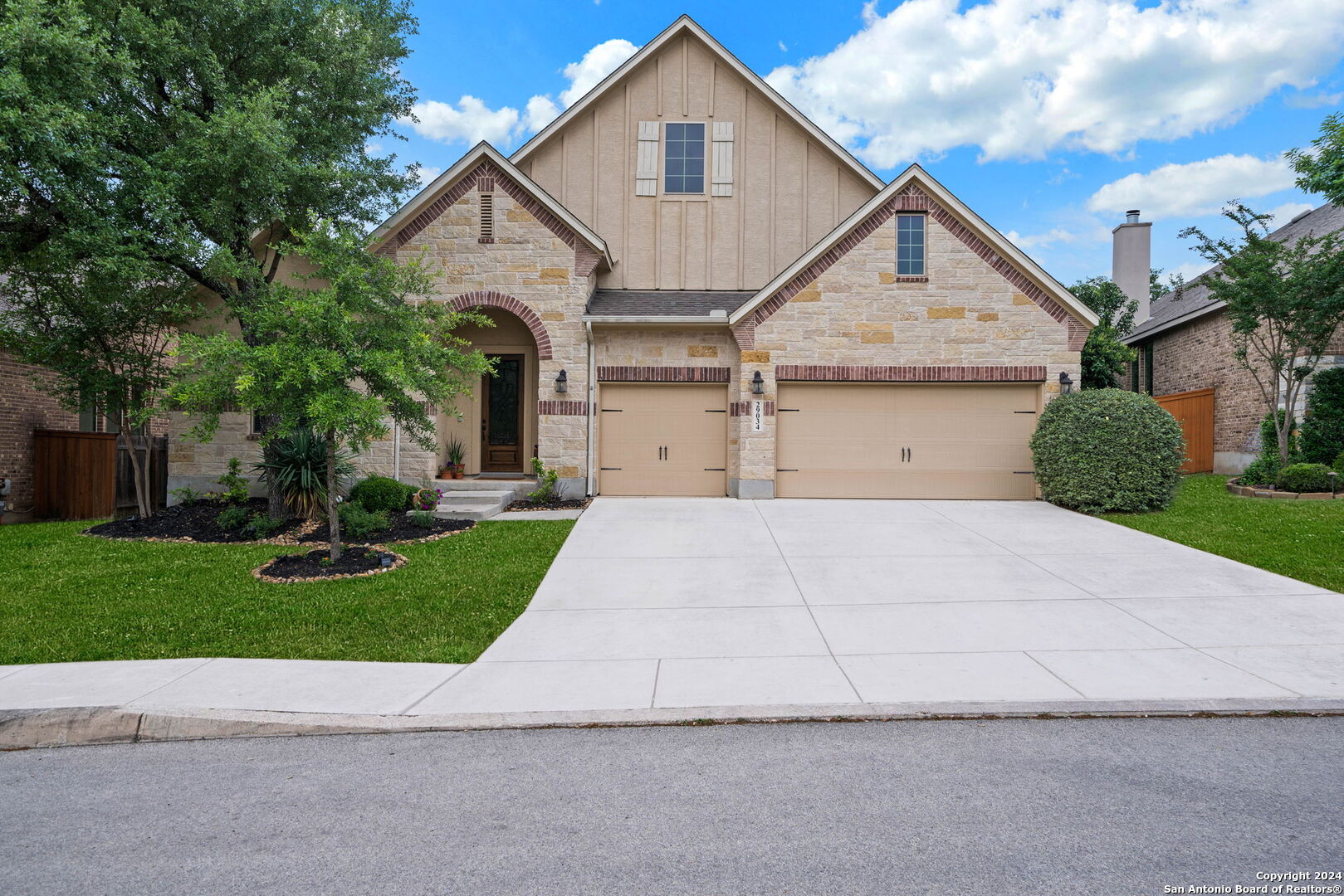 a front view of a house with a yard and garage