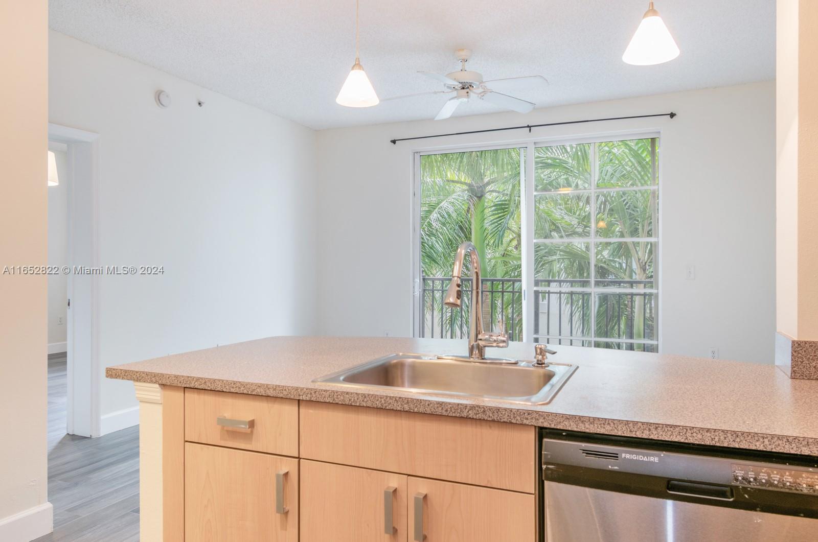 a kitchen with a sink and large window