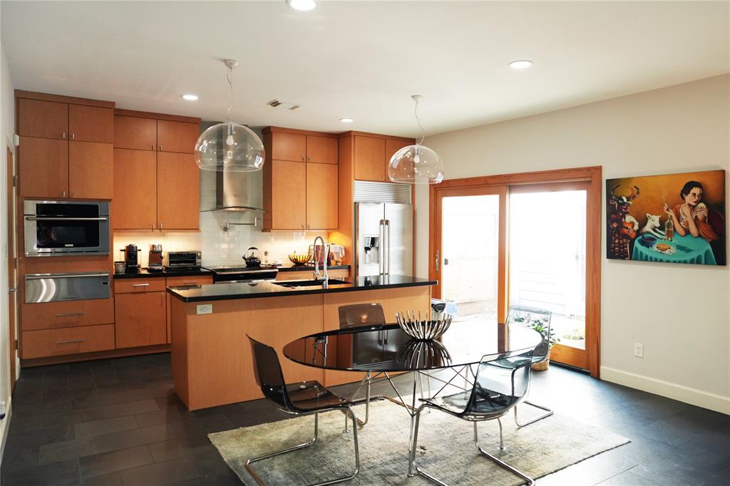 a large kitchen with lots of counter space and windows