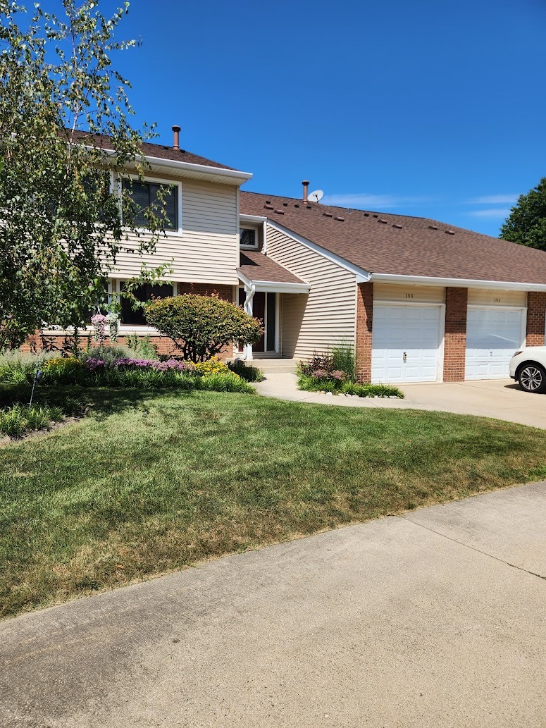 a front view of house with yard and green space