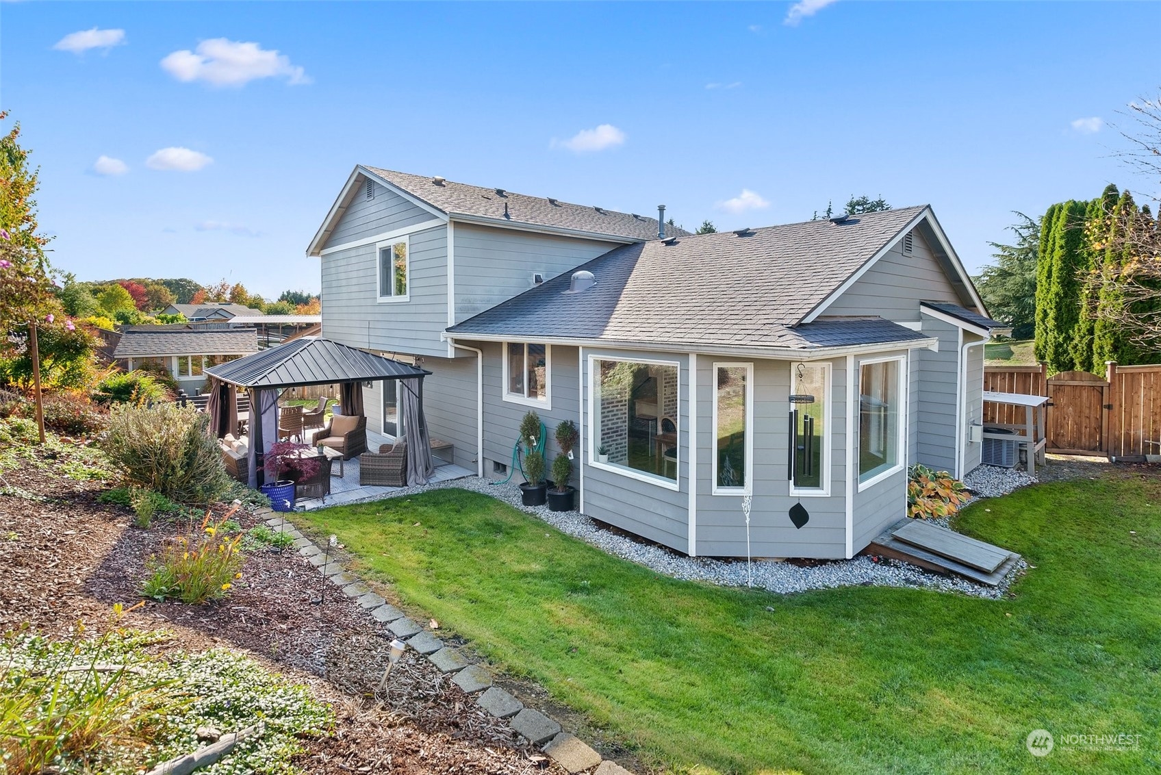 a view of a house with a yard and sitting area