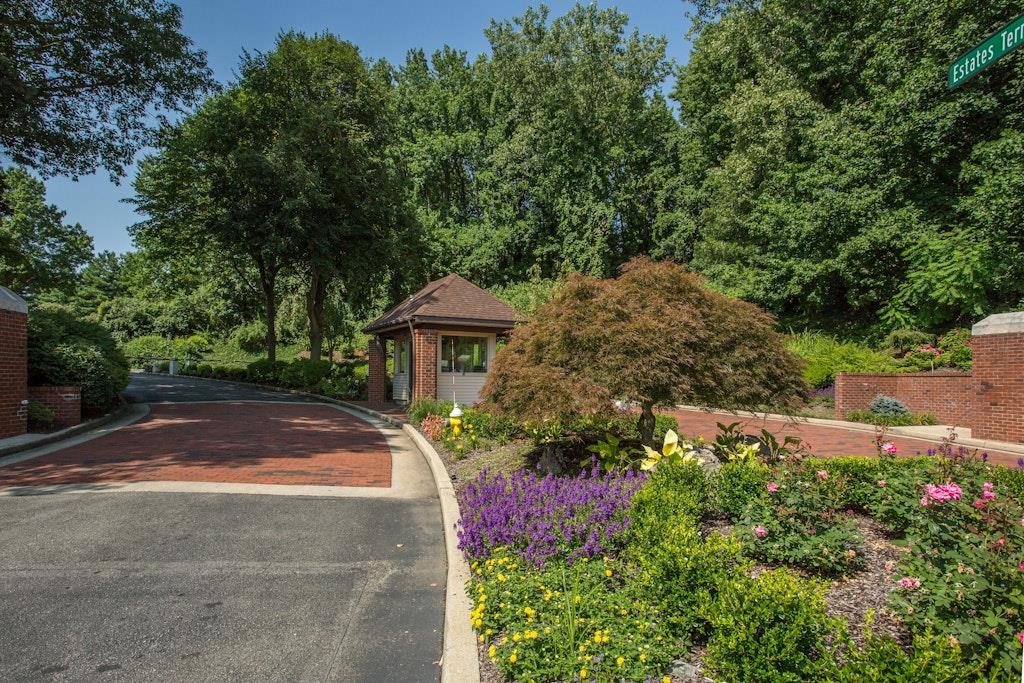 a front view of a house with a yard and shrubs