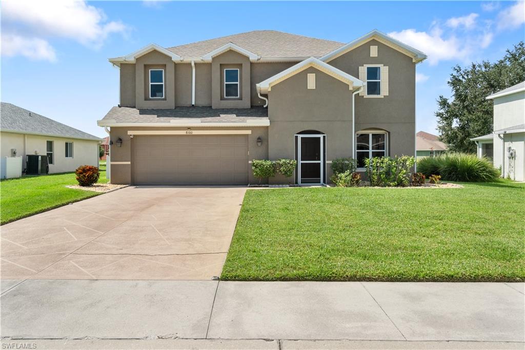 a front view of house with yard and green space