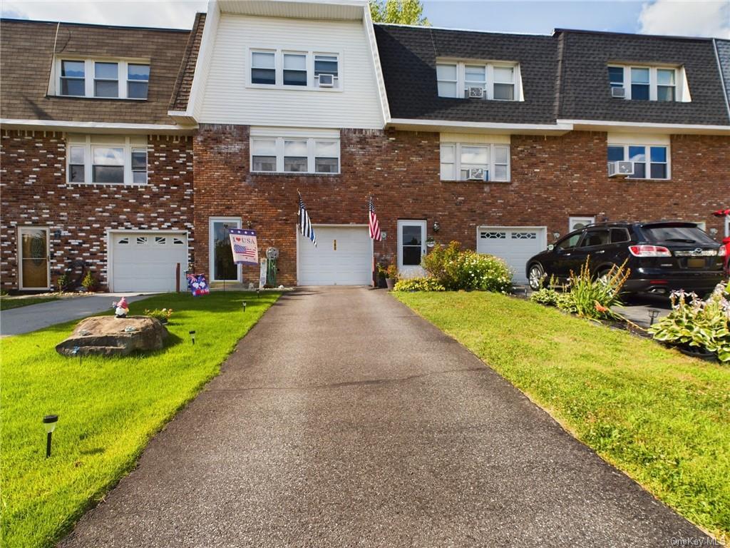 Property with garage and a front yard