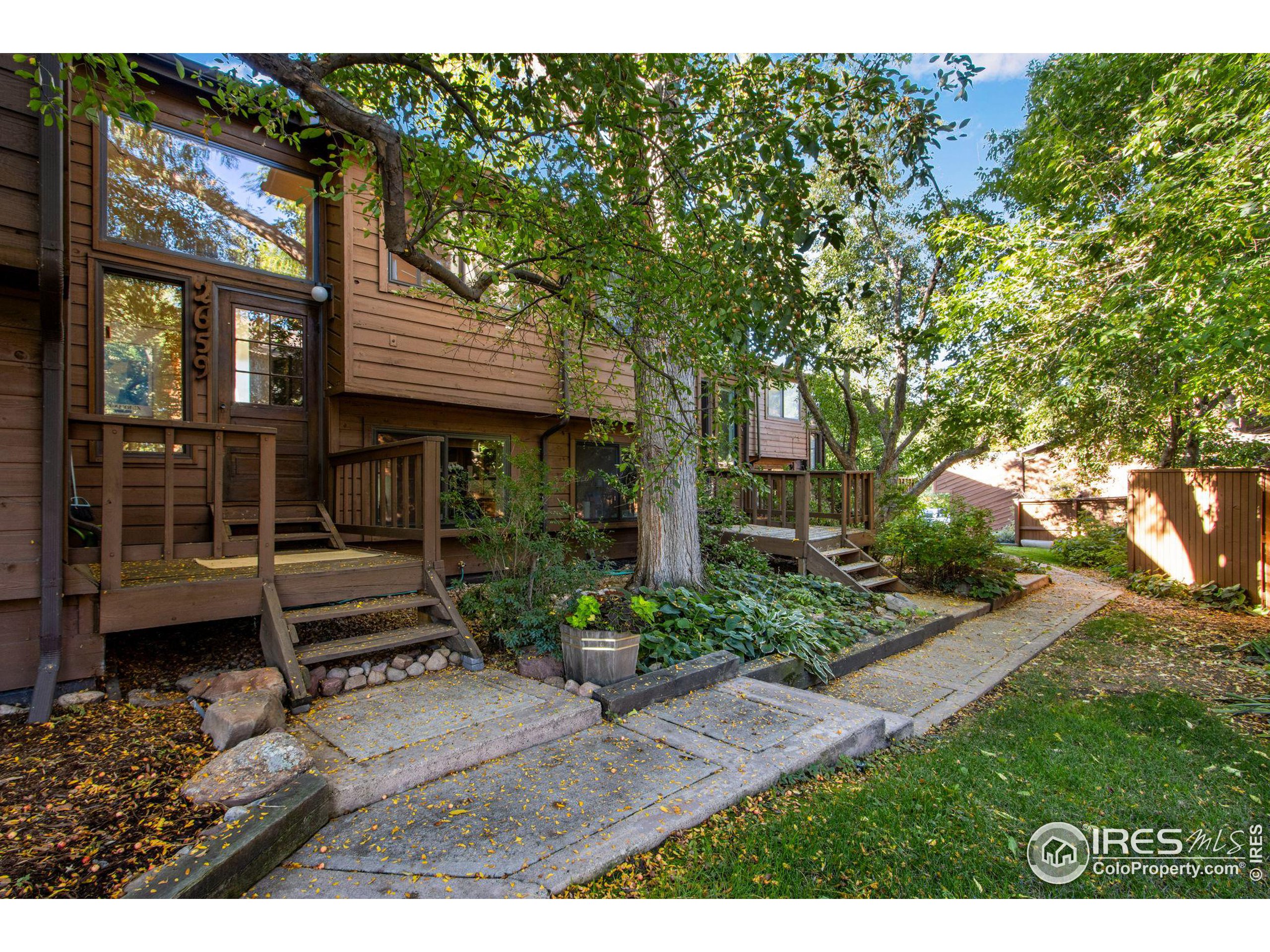 a backyard of a house with barbeque oven table and chairs