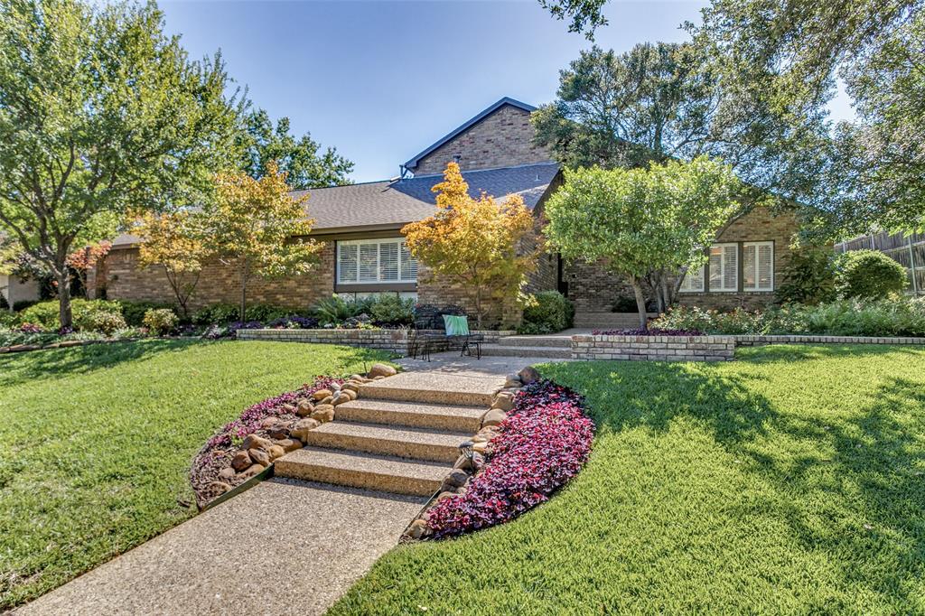 a front view of a house with a yard and a fence