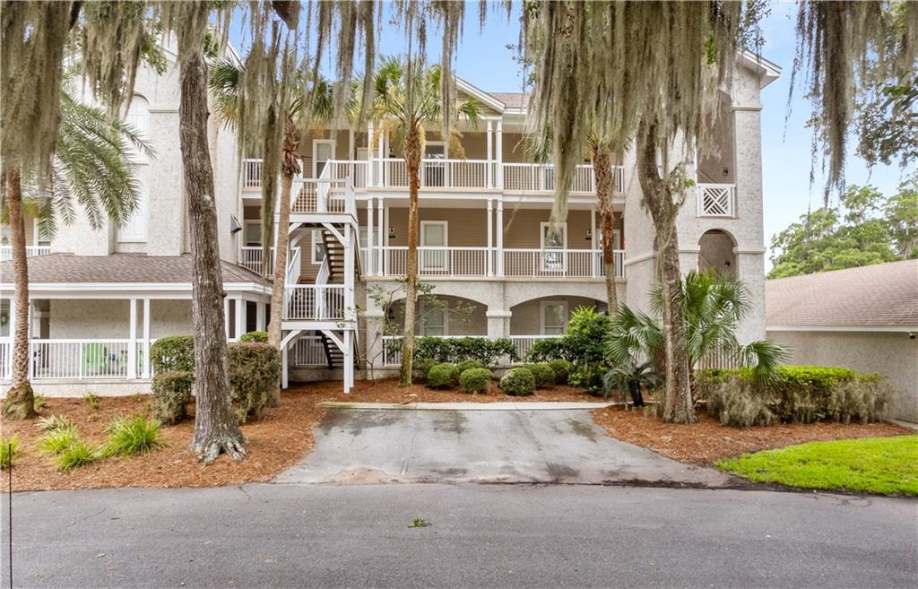 a front view of a multi story residential apartment building with a yard