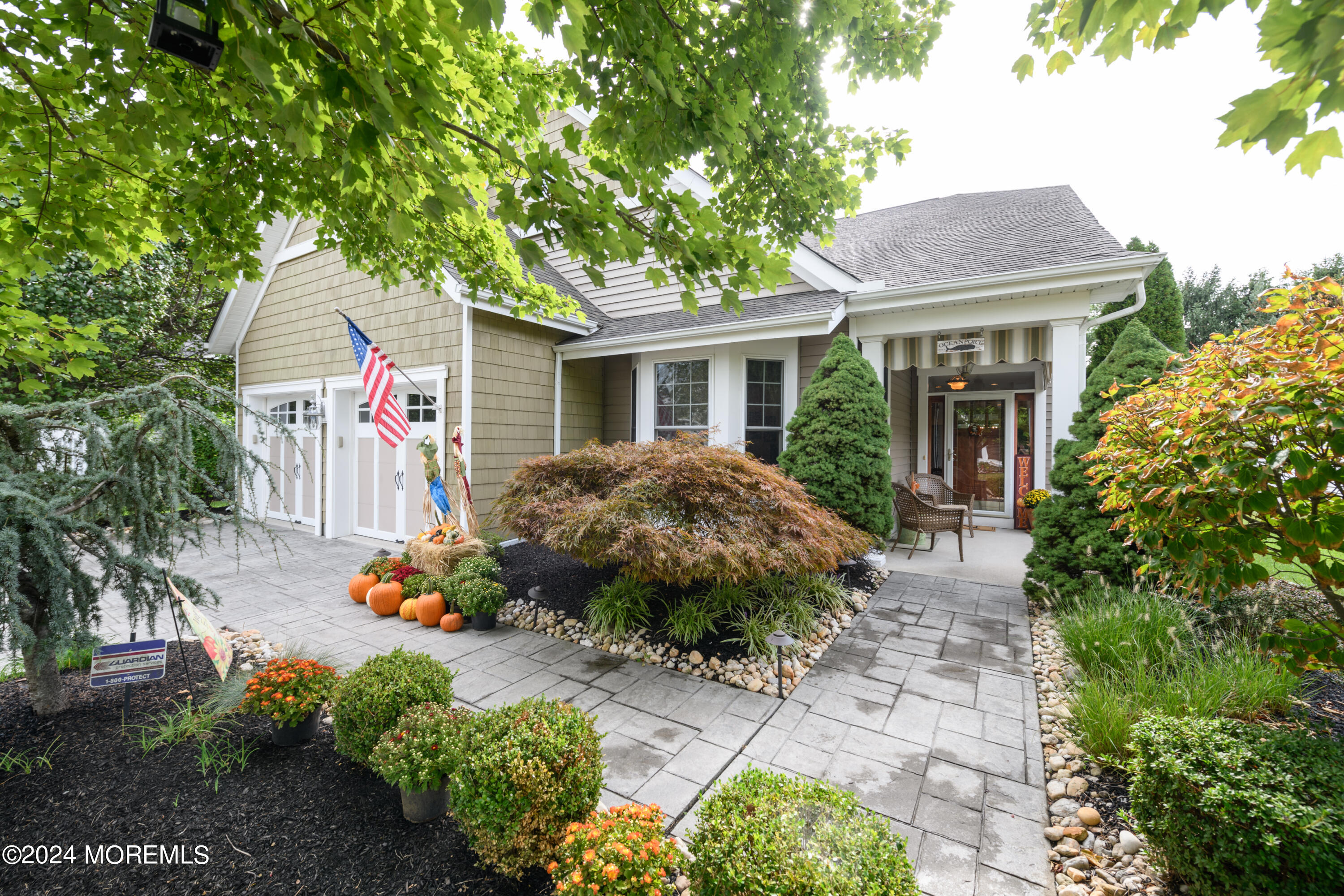 a backyard of a house with a garden and outdoor seating