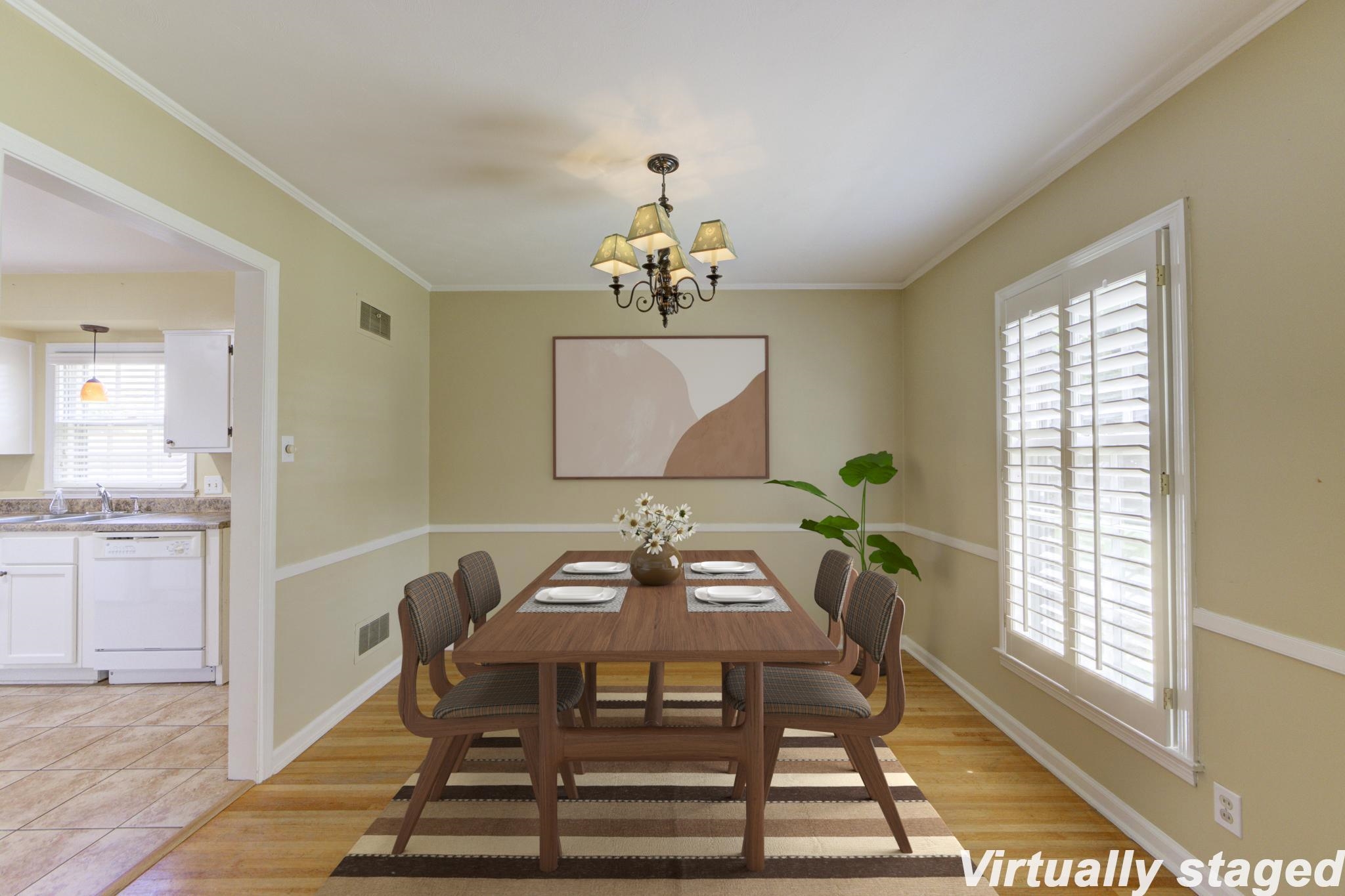 a dining room with furniture a rug and a chandelier