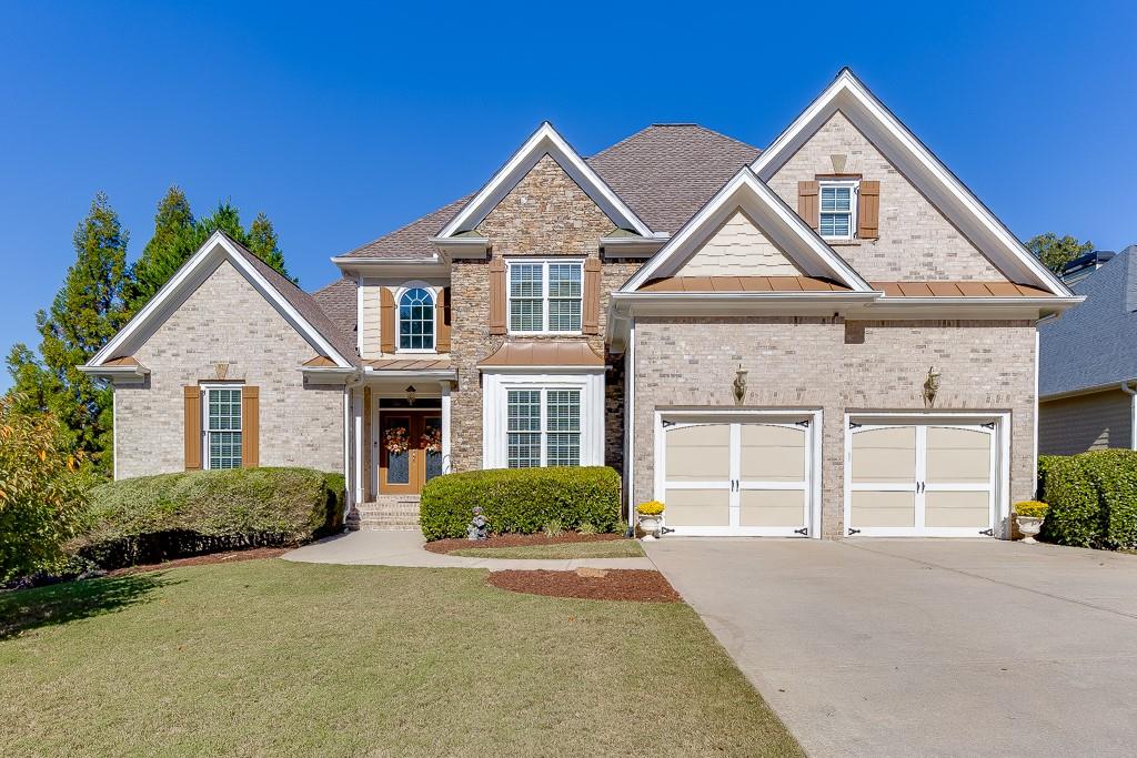 a front view of a house with a yard and garage