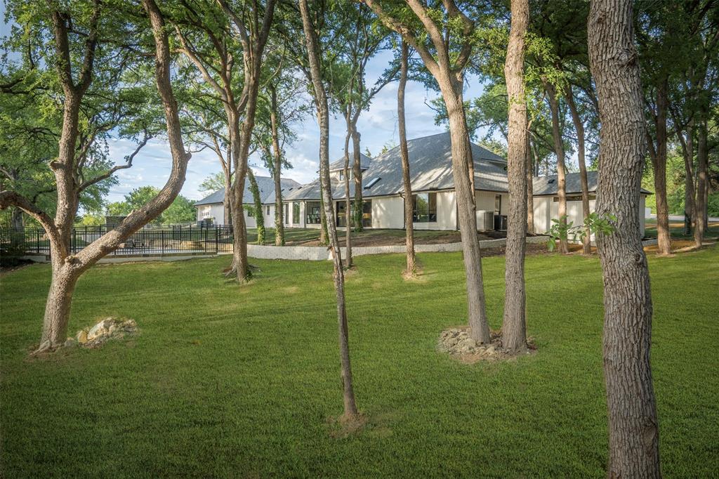 a backyard of apartments with large trees