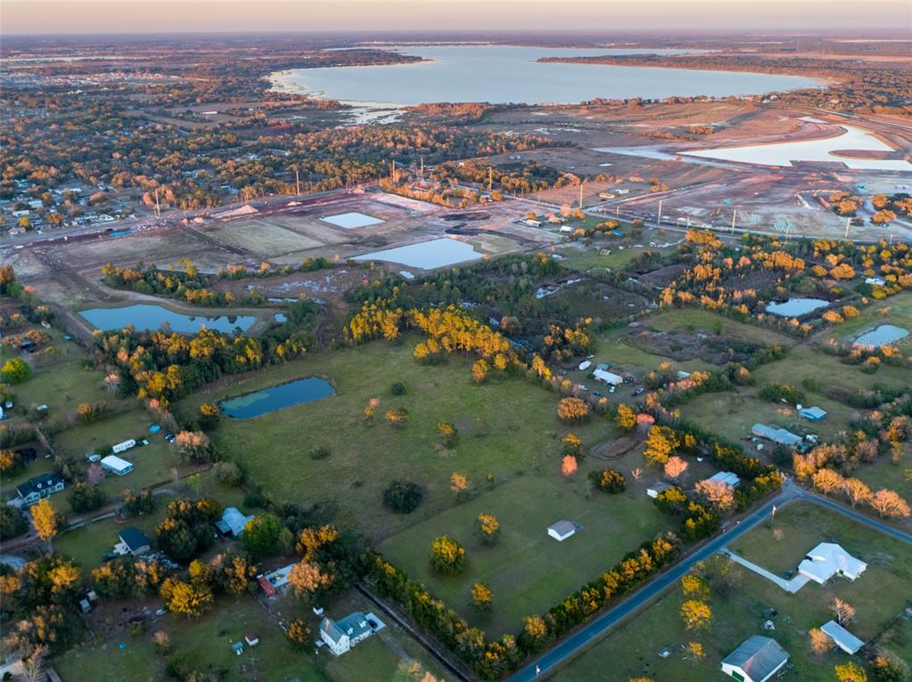 14.52 beautiful acres in the Manor, Alligator Lake in distance. National builders building to the north and to the east