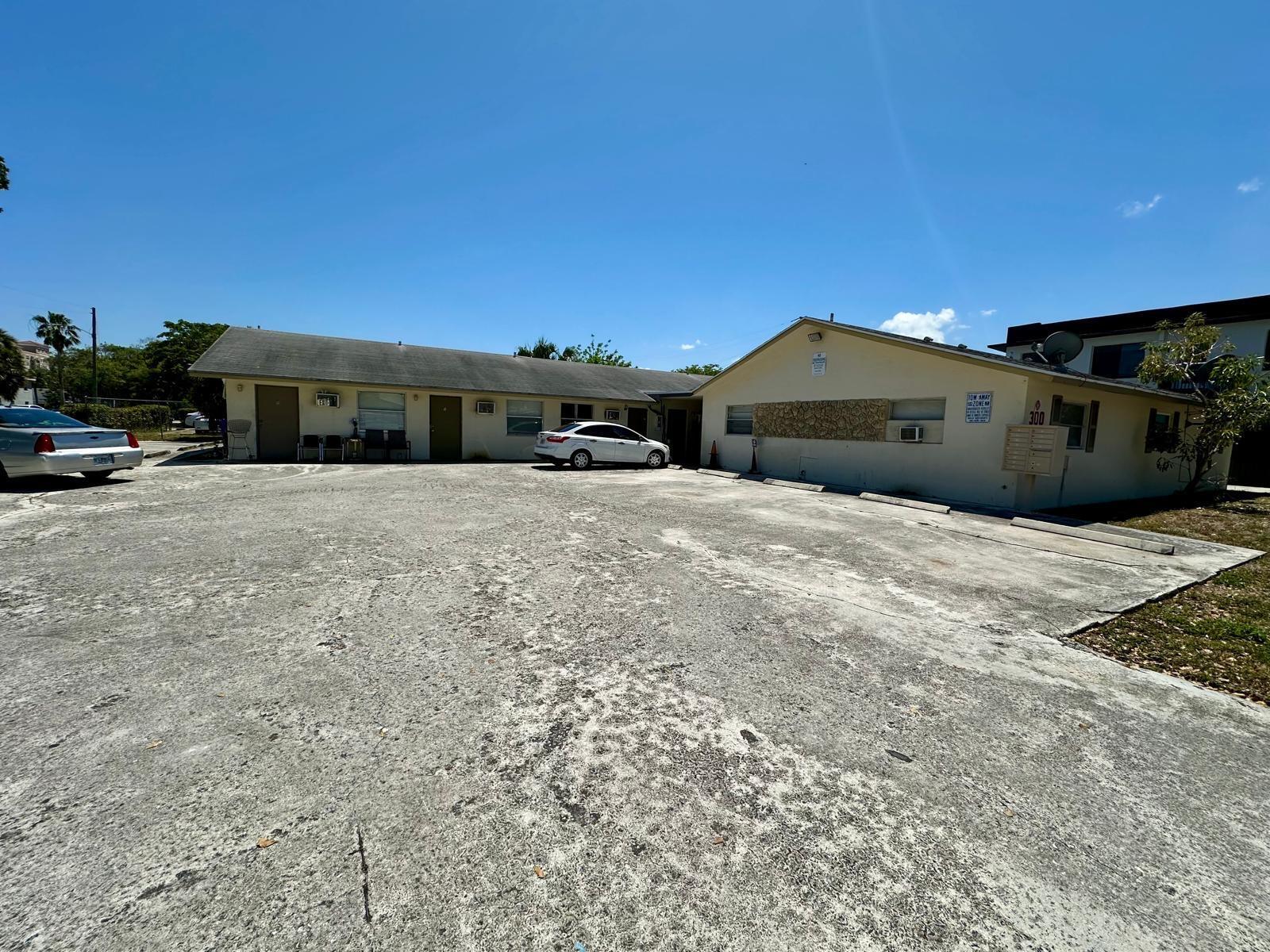 a view of a car park in front of a house