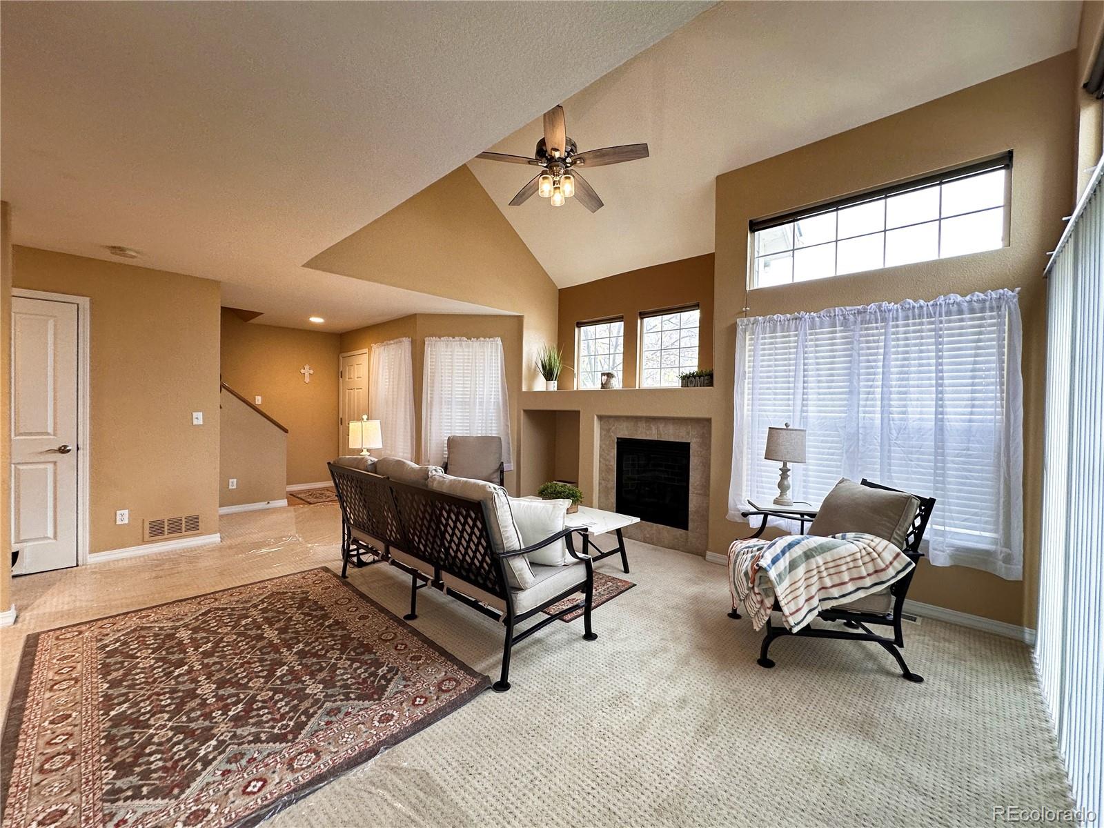 a living room with furniture and a fireplace