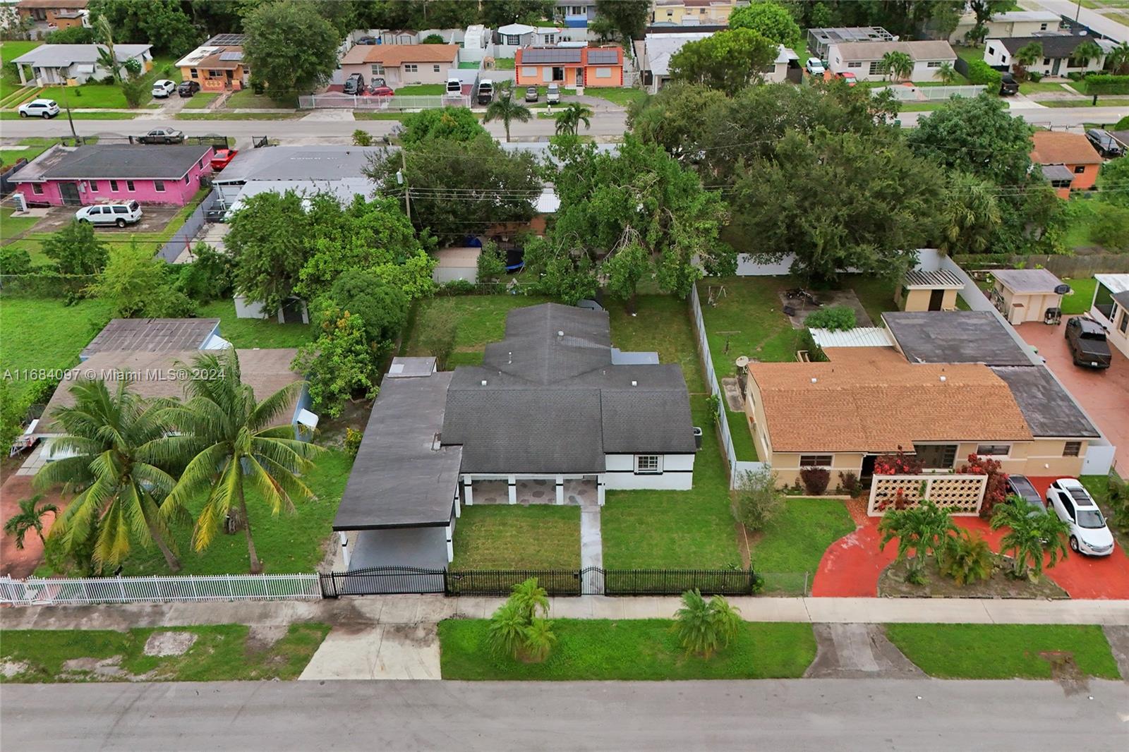 an aerial view of multiple houses with a yard