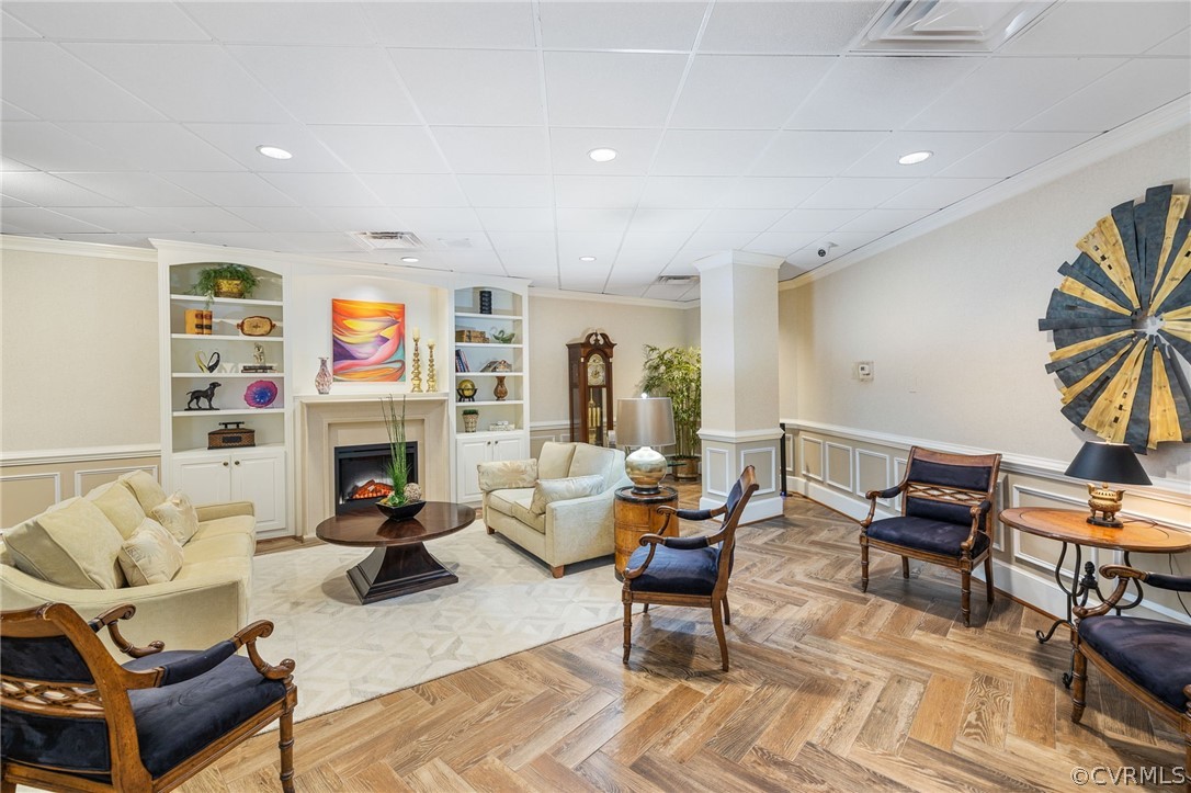 a living room with furniture fireplace and a table