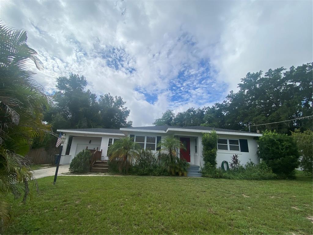 a front view of house with yard and green space