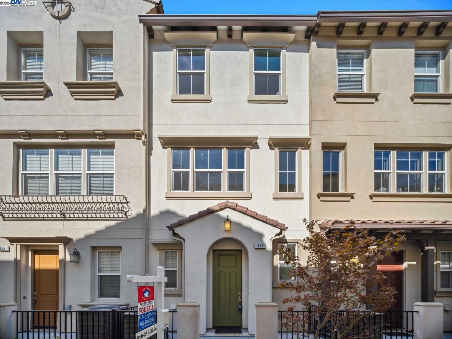 a front view of a residential apartment building with a lot of windows