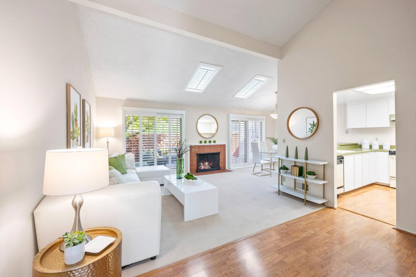 a living room with furniture a fireplace and a large window