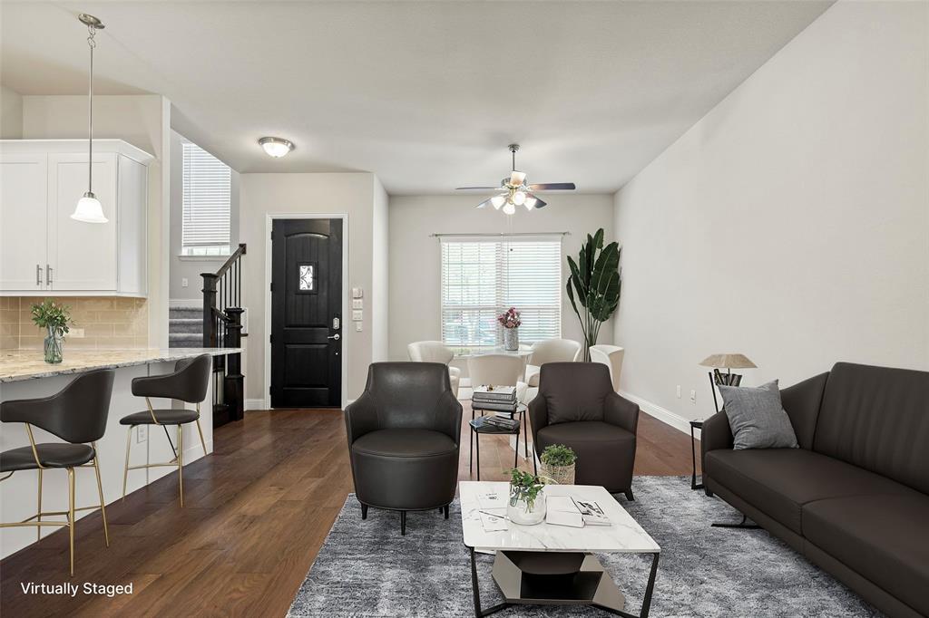 a living room with furniture a chandelier and a dining table