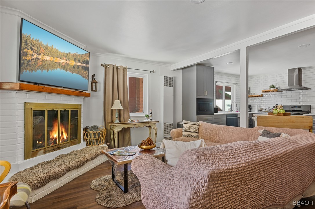 a living room with furniture kitchen view and a fireplace