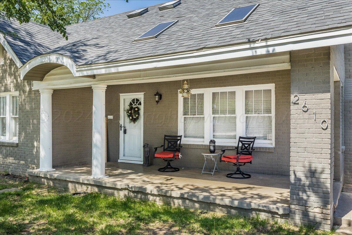 a view of a house with outdoor seating space