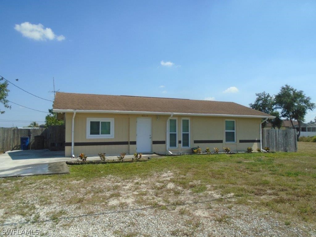 a view of a house with yard and sitting area