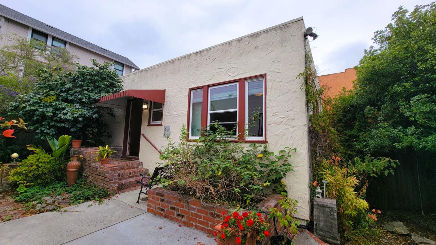 front view of a house with potted plants