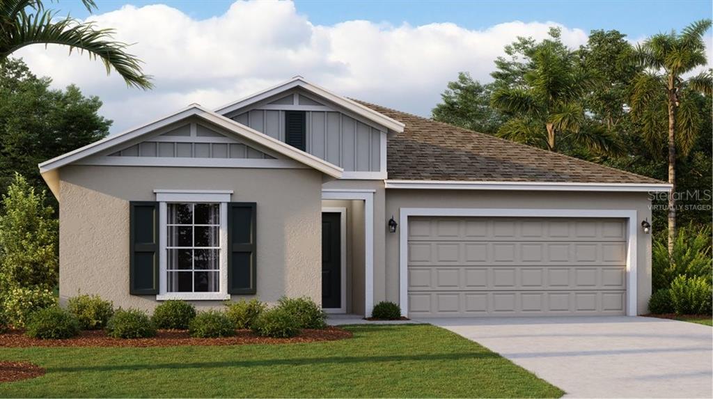 a front view of a house with a yard garage and trees