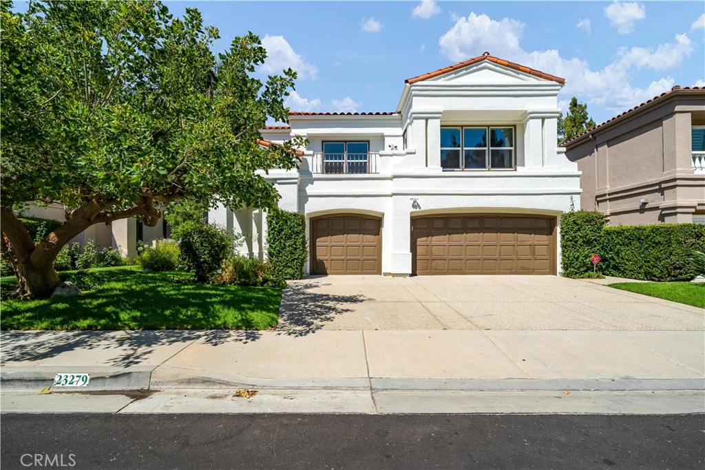 a front view of a house with a yard and a garage